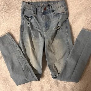 Light wash denim with holes